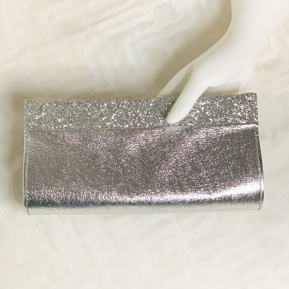 Silver clutch handbag with glitter trim and hinge open and close